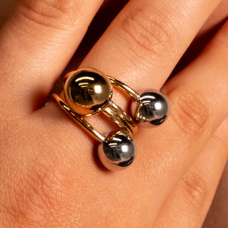 Close-up detail of the Chelsea Sphere Ring showing its sculptural three-sphere two-toned design in polished gold and silver.