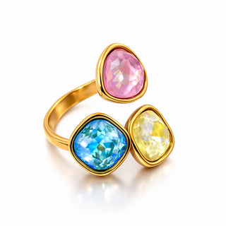Close-up of the Aurora Prism Ring showing pink, blue and yellow faceted stones set in rich gold plating for a modern, bold Forward & Tame statement.