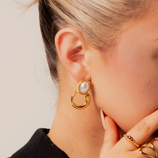 Cara Pearl Twist Hoops 18k gold pearl drop hoop earrings close up on ear
