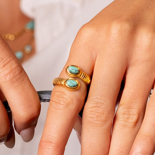 Ios Turquoise Snake Ring 18k gold natural turquoise snake ring close up on finger
