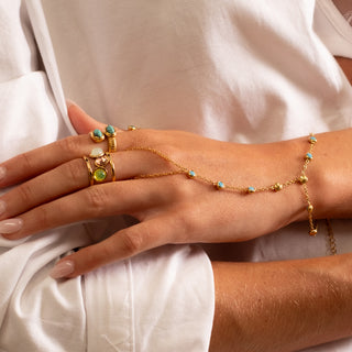 Island Turquoise Hand Chain 18k gold turquoise CZ hand chain styled with stacked Island Collection rings
