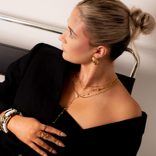 Leah Drop V Necklace 18k gold beaded lariat necklace styled with Elegance Collection layered gold necklaces and pearl hoops