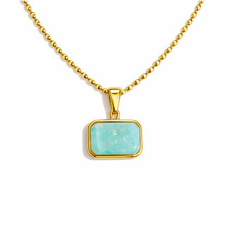 Close-up of a gold beaded-chain necklace featuring a rectangular amazonite pendant in a polished 18k gold bezel, photographed on a bright white background. The stone has soft turquoise tones and natural texture, with a high-shine, luxury finish.